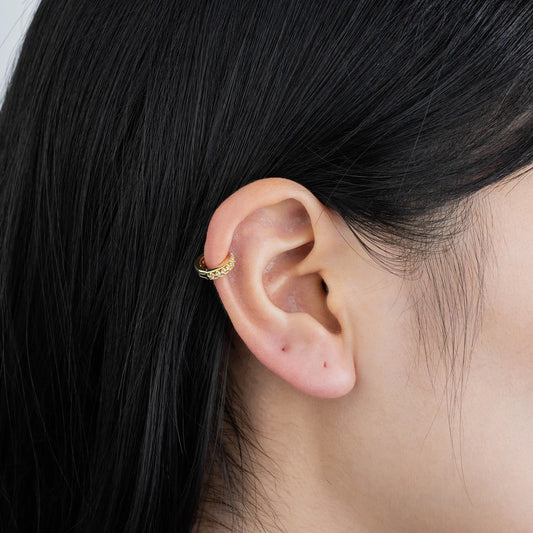 Ajatine gold huggie earrings with zircon stones, showcasing classic elegant design for daily wear