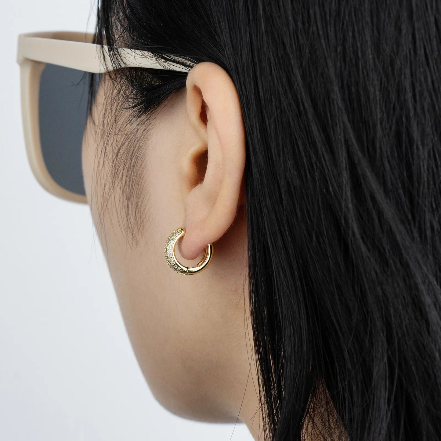 Gold huggie earrings with cubic zirconia, ideal for daily and party styling