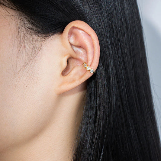 Ajatine gold ear cuffs adorned with zircon stones, perfect for stylish ear jewelry looks