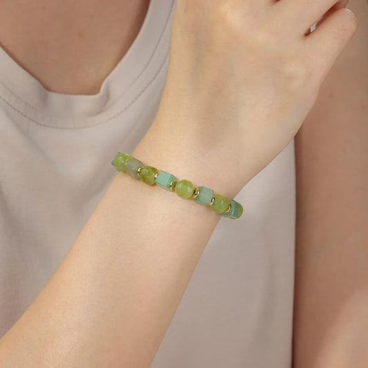 A green beaded bracelet with an elegant design.