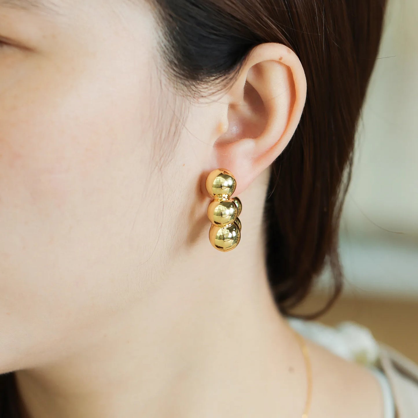 Ajatine beaded hoop earrings with stacked gold ball design, perfect for chic and versatile styling