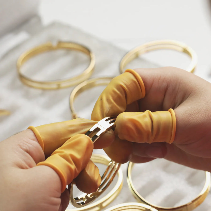 Designer holding a bundle of gold chains