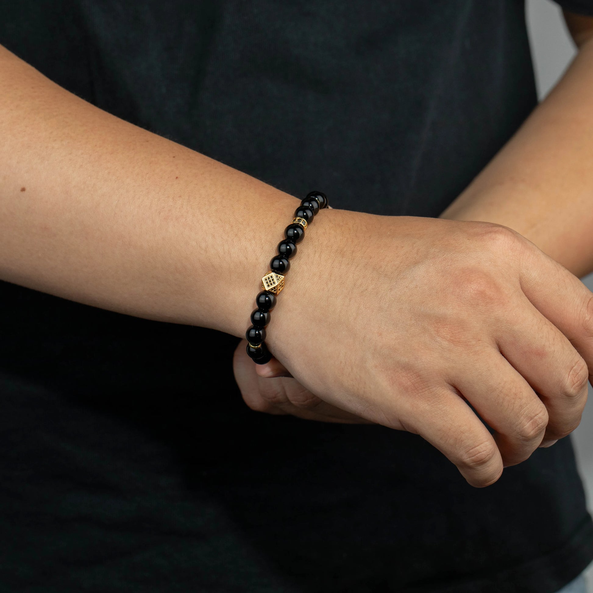 Ajatine black natural stone beaded bracelet with gold accents