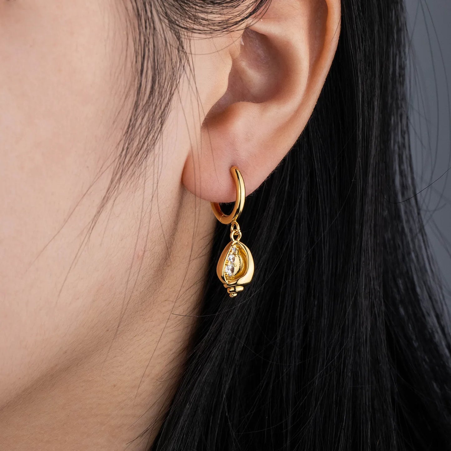 Gold tone conch shell dangle earrings with sparkling zircon, coastal style jewelry