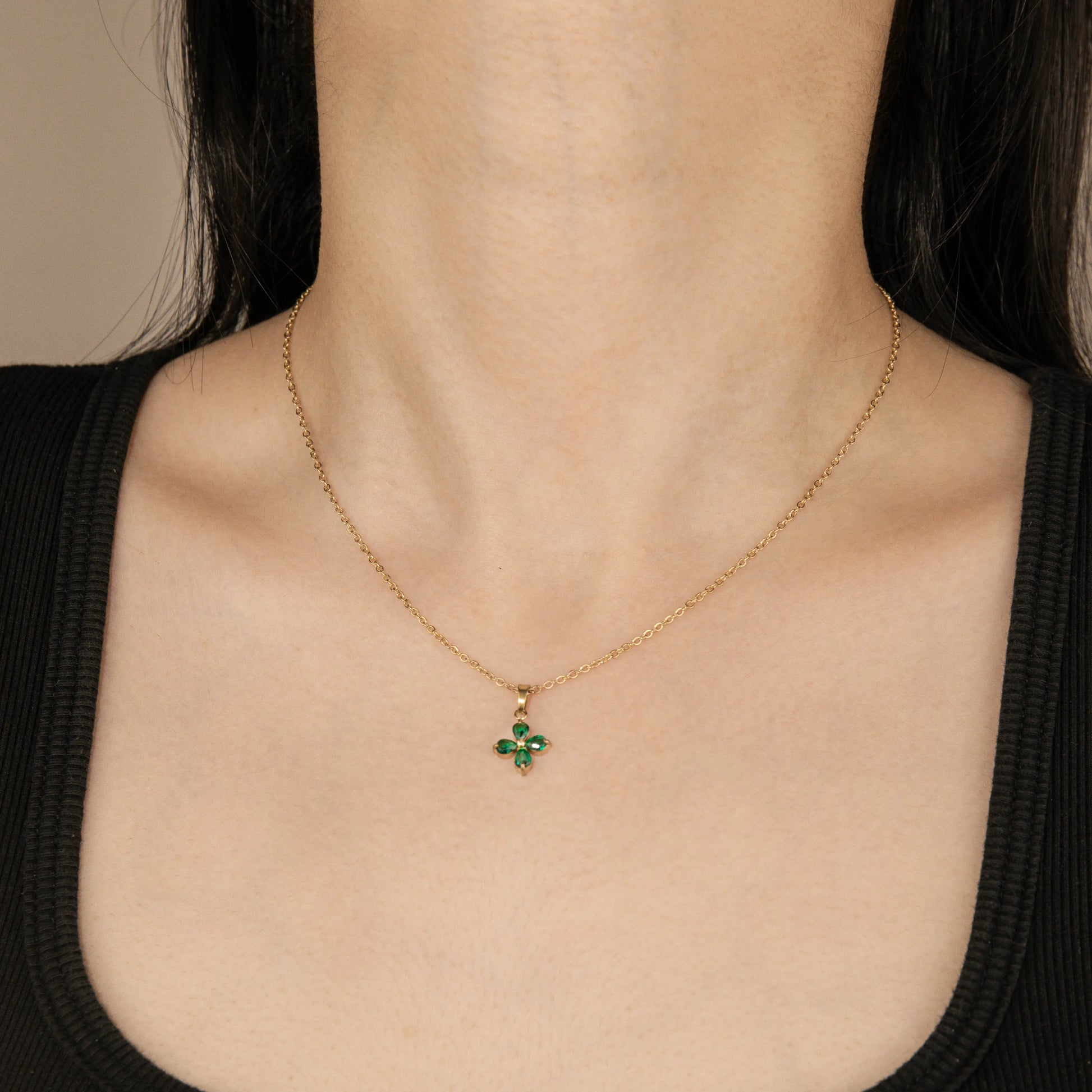 Ajatine four leaf clover necklace with gold chain and green crystal pendant