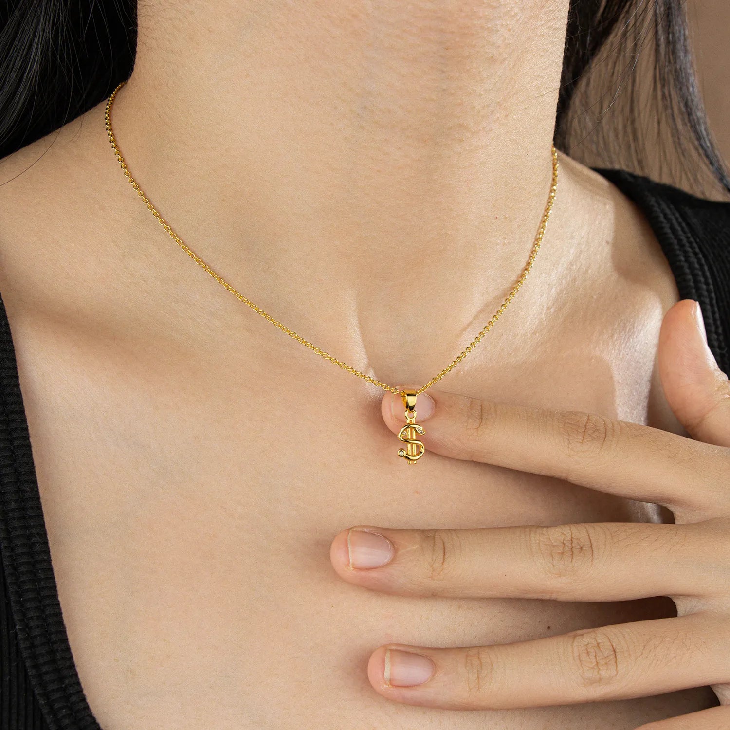 Trendy gold dollar sign pendant necklace with subtle sparkles, a stylish accessory for everyday wear and party occasions