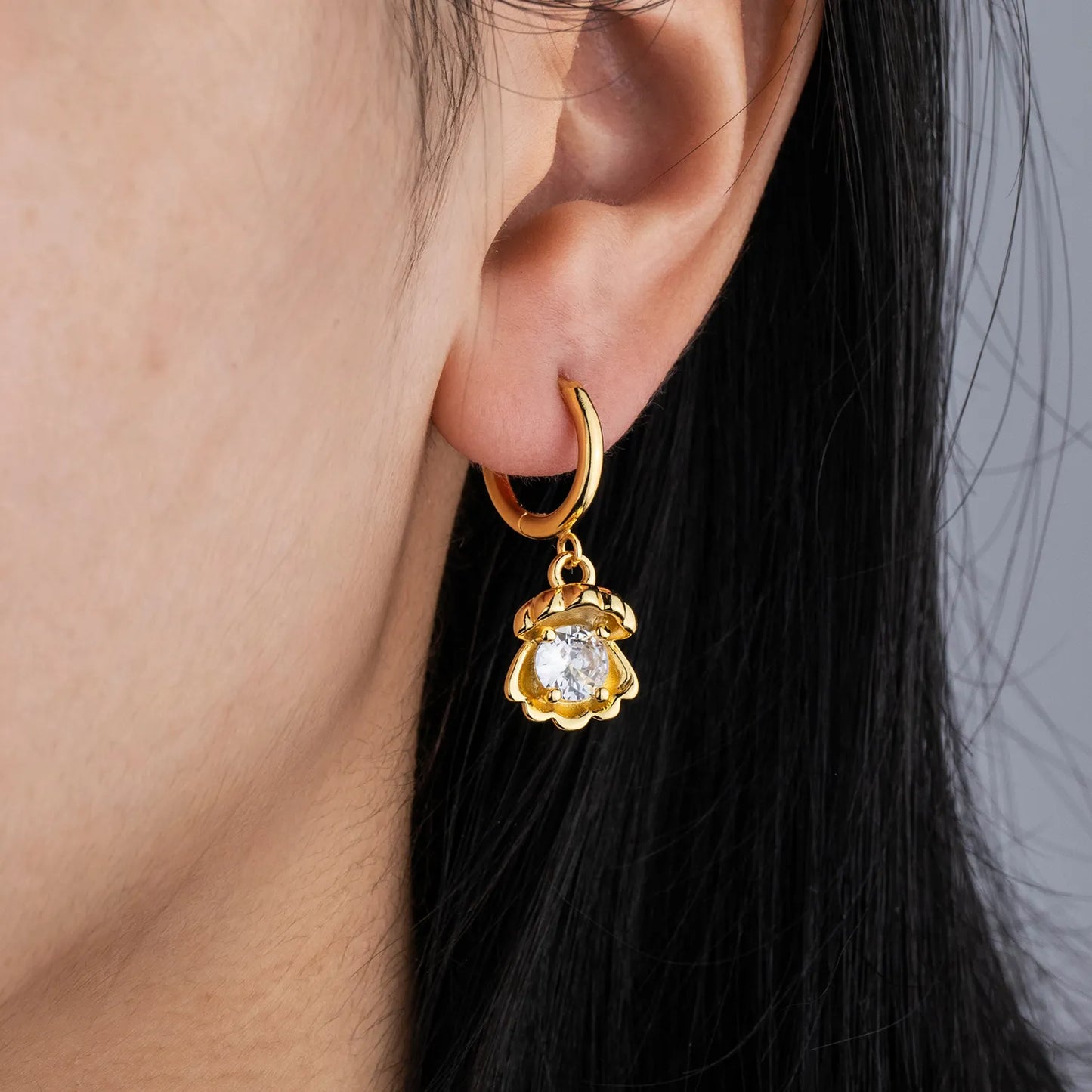 Dainty gold shell earrings with sparkling accent