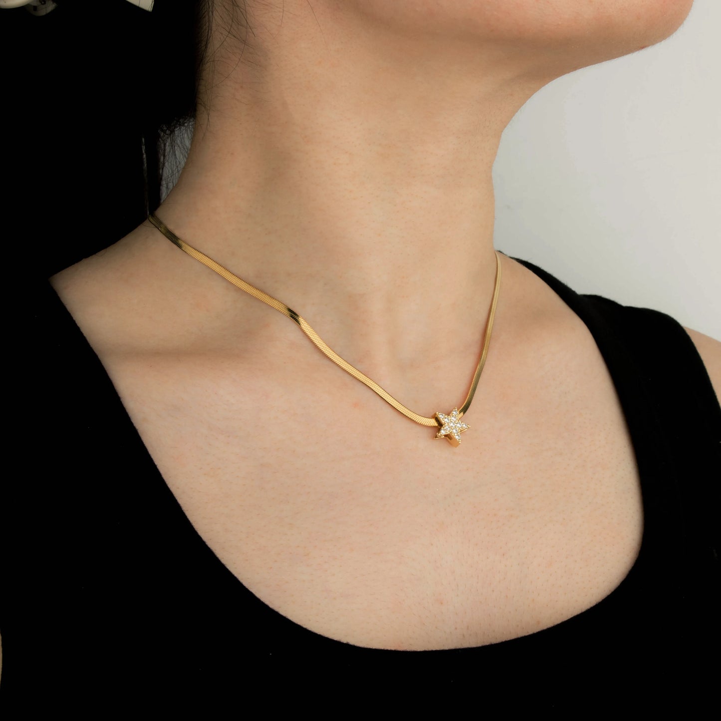 Ajatine gold star necklace with cubic zirconia on snake chain