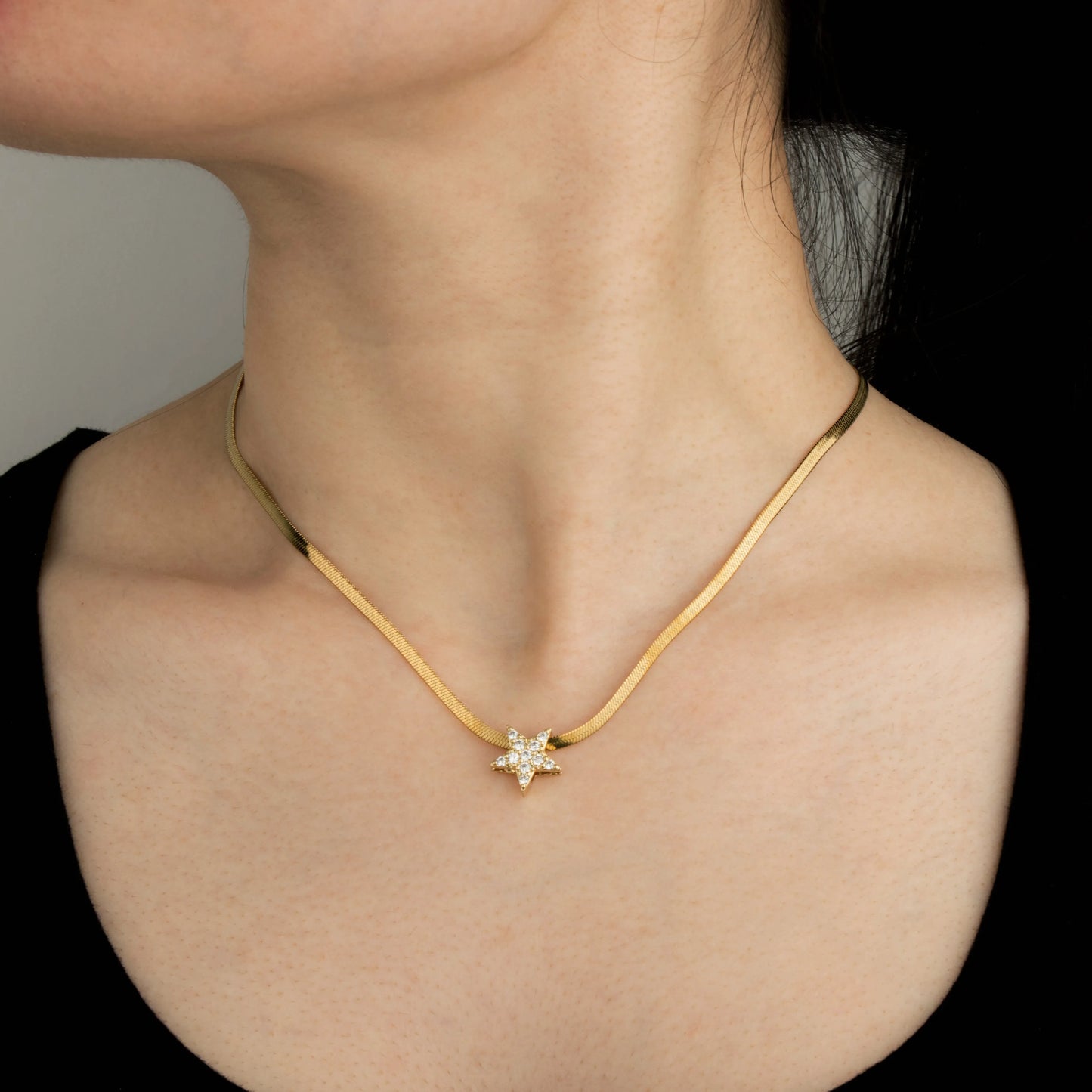 Ajatine gold star necklace with cubic zirconia on snake chain