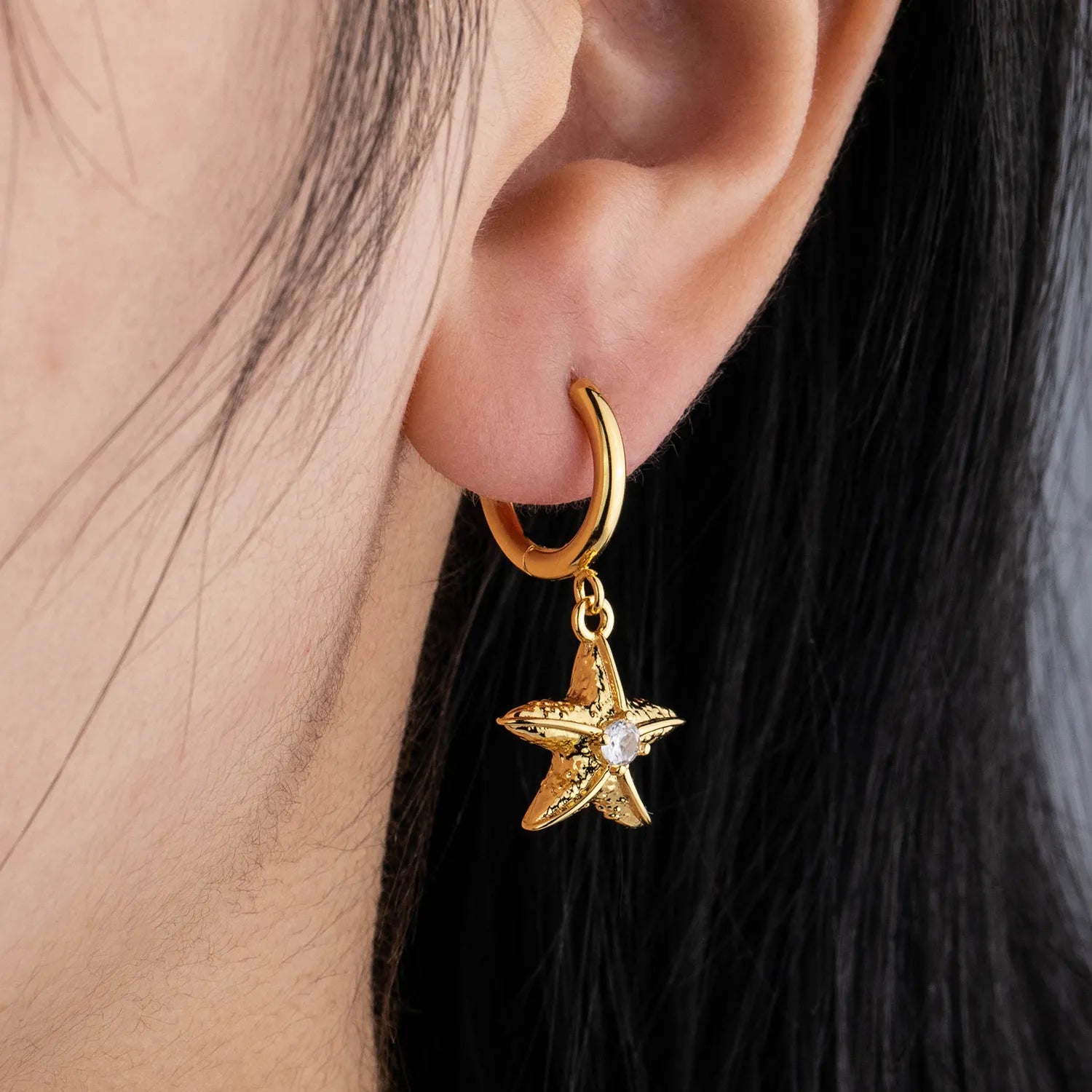 Ajatine gold starfish dangle hoop earrings with sparkling accent for summer beach style
