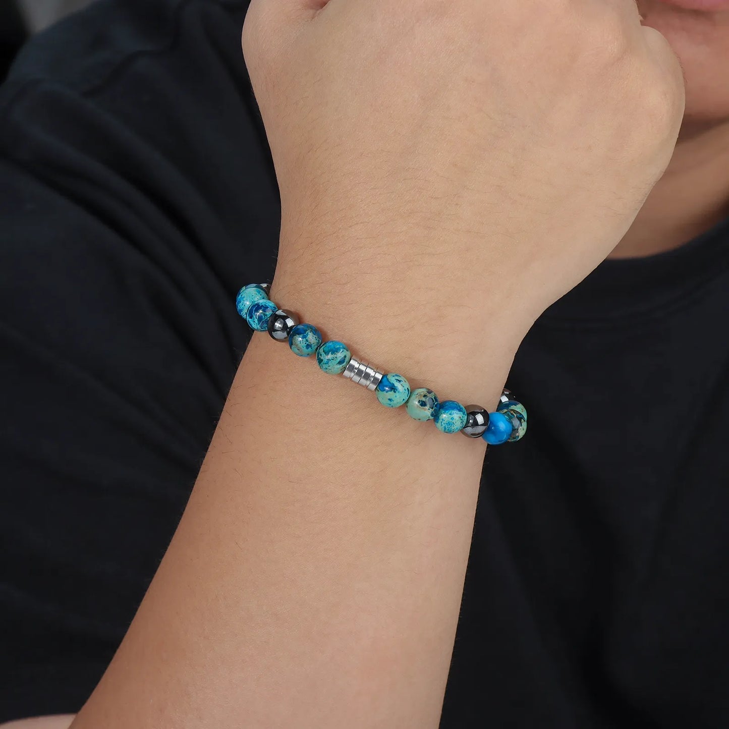 Beaded bracelet with blue stones, black beads and stainless steel clasp.