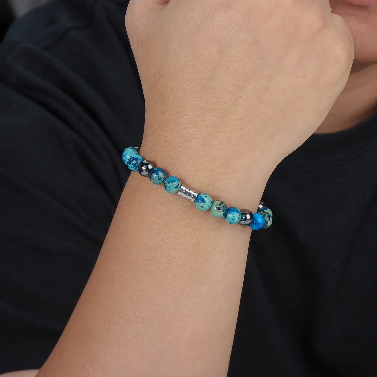 Beaded bracelet with blue stones, black beads and stainless steel clasp.