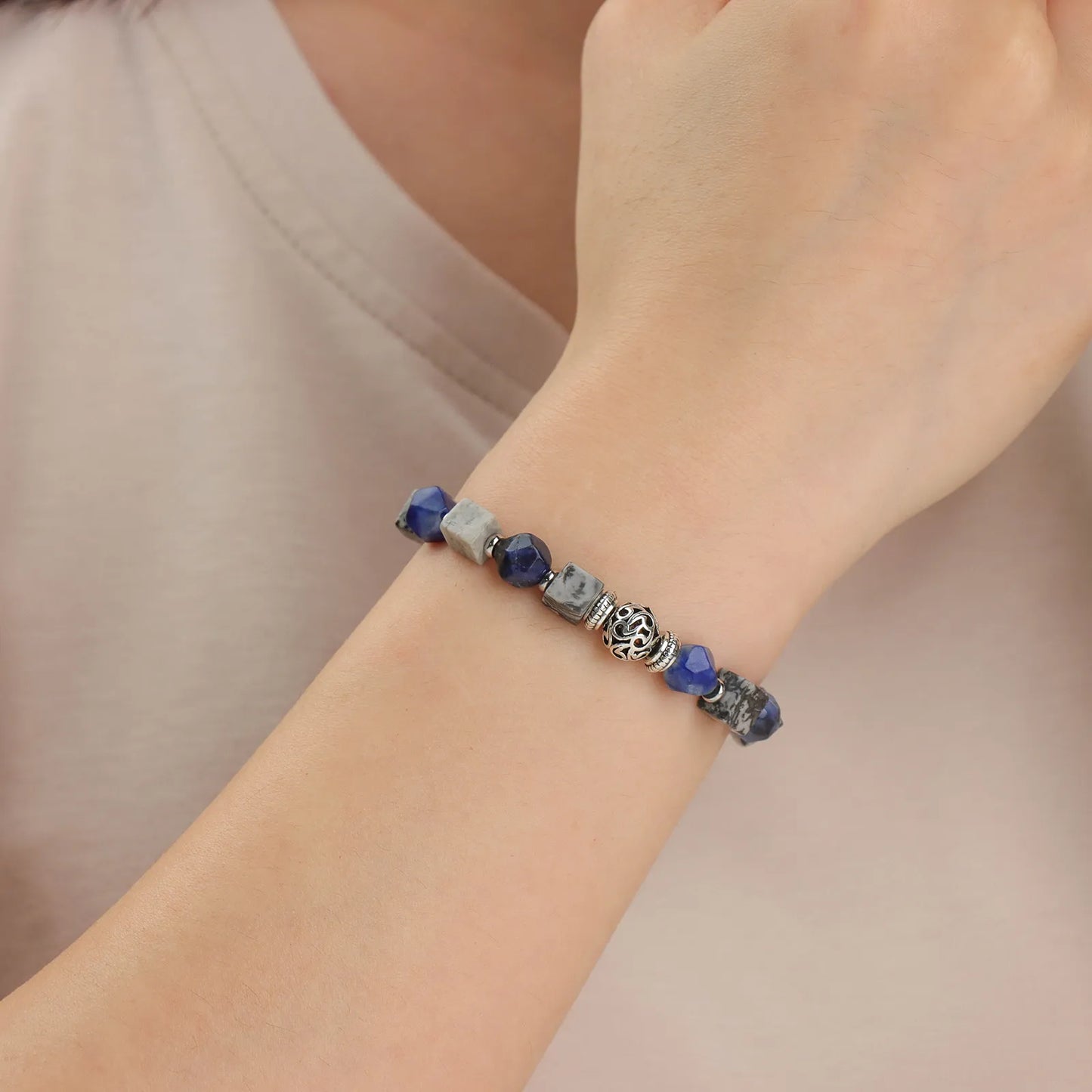 Blue gray stone beaded bracelet with intricately designed silver accents.