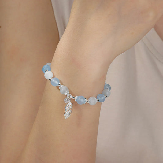 Beaded bracelet with blue and white stones and star feather charm.