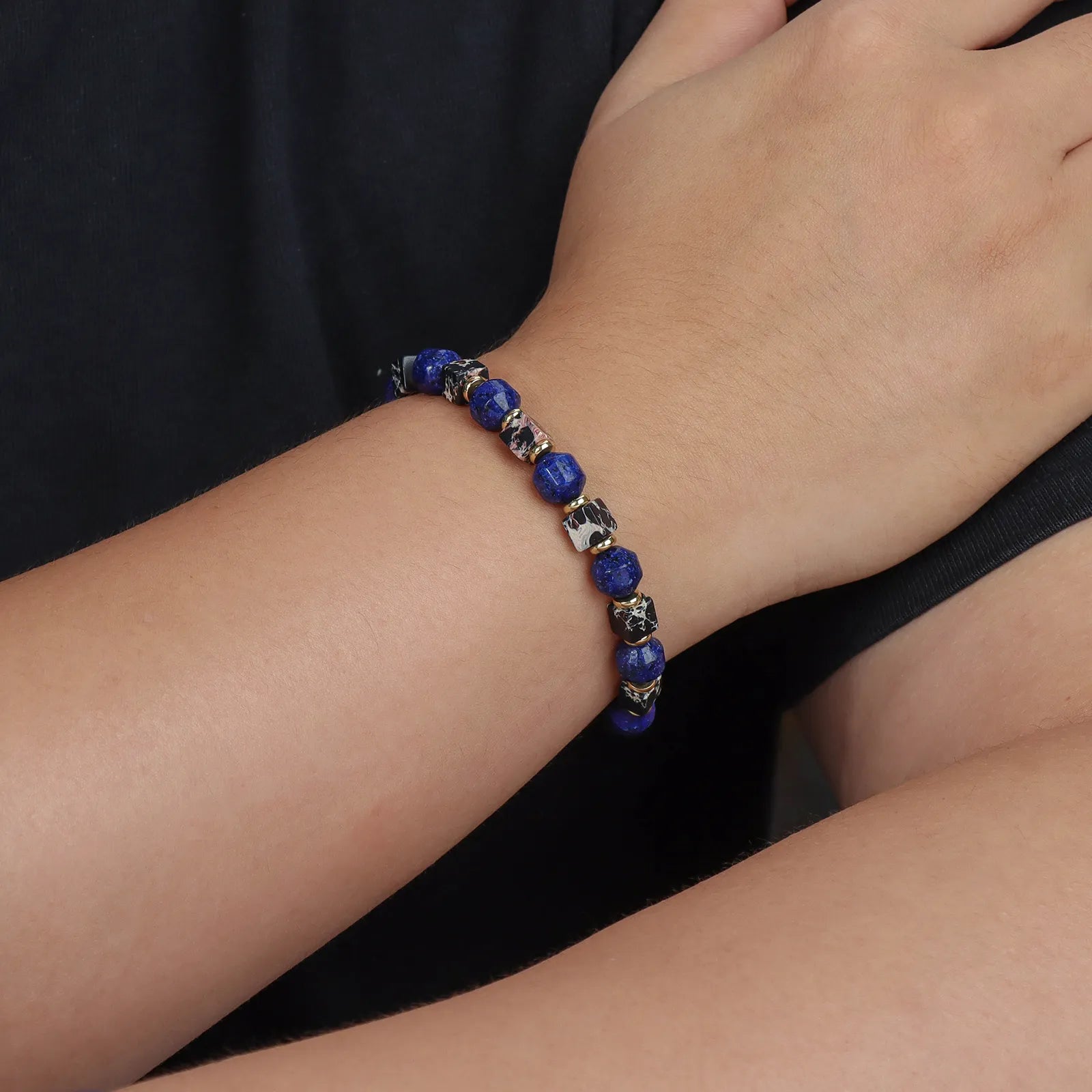 Stylish bracelet made of blue and black stone beads with gold - toned accents.