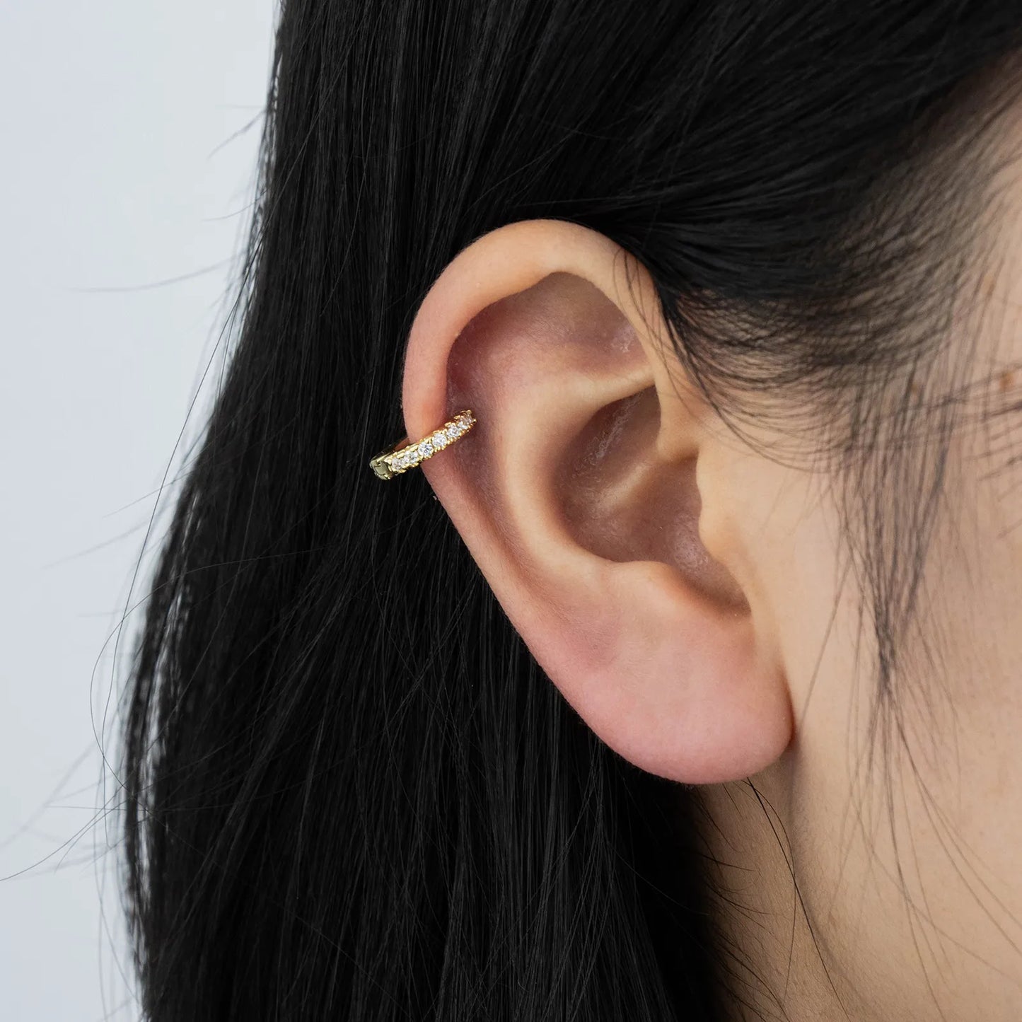Ajatine chic gold hoop earrings with sparkling cubic zirconia stones, showcasing a delicate and stylish design for daily wear, catching light beautifully