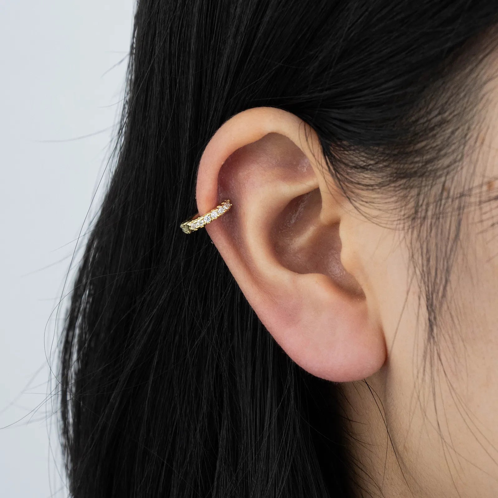 Ajatine chic gold hoop earrings with sparkling cubic zirconia stones, showcasing a delicate and stylish design for daily wear, catching light beautifully