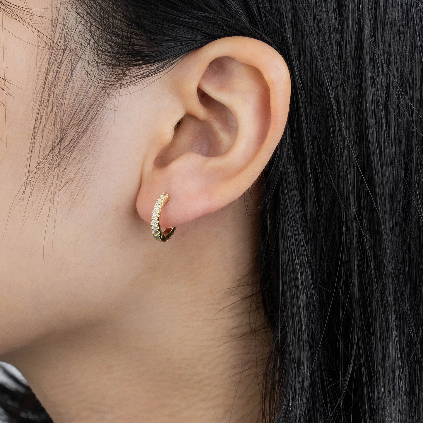 Ajatine chic gold hoop earrings with sparkling cubic zirconia stones, showcasing a delicate and stylish design for daily wear, catching light beautifully