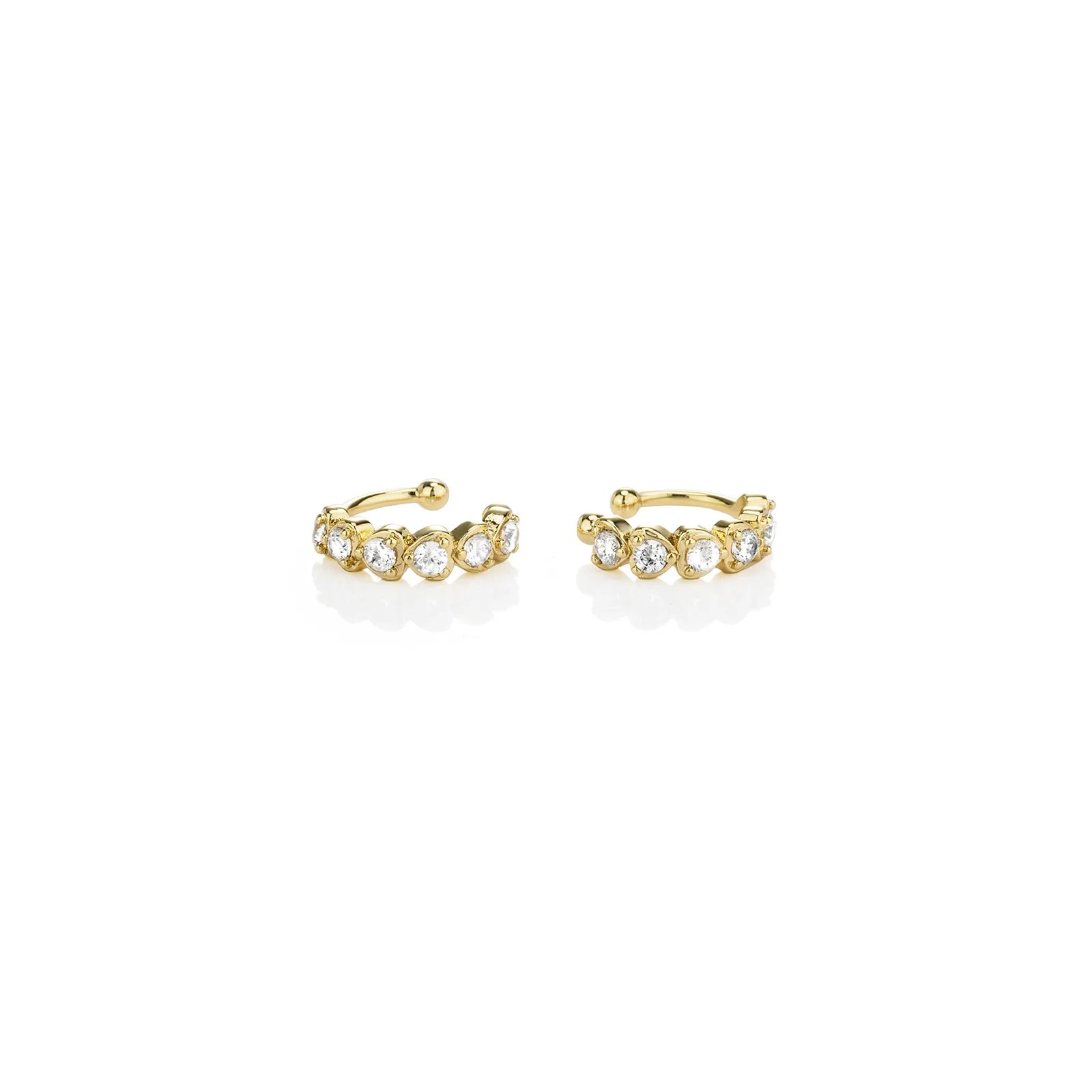 Pair of gold toned ear cuffs with cubic zirconia stones, showcasing a stylish and delicate design