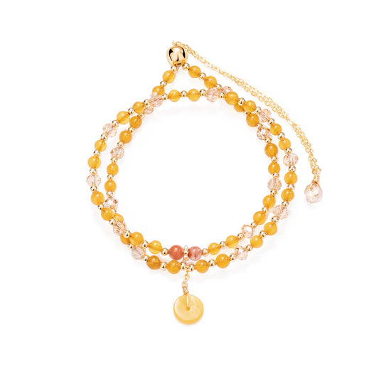 A double - layered beaded bracelet with yellow and light pink beads and a gold - tone disc charm.