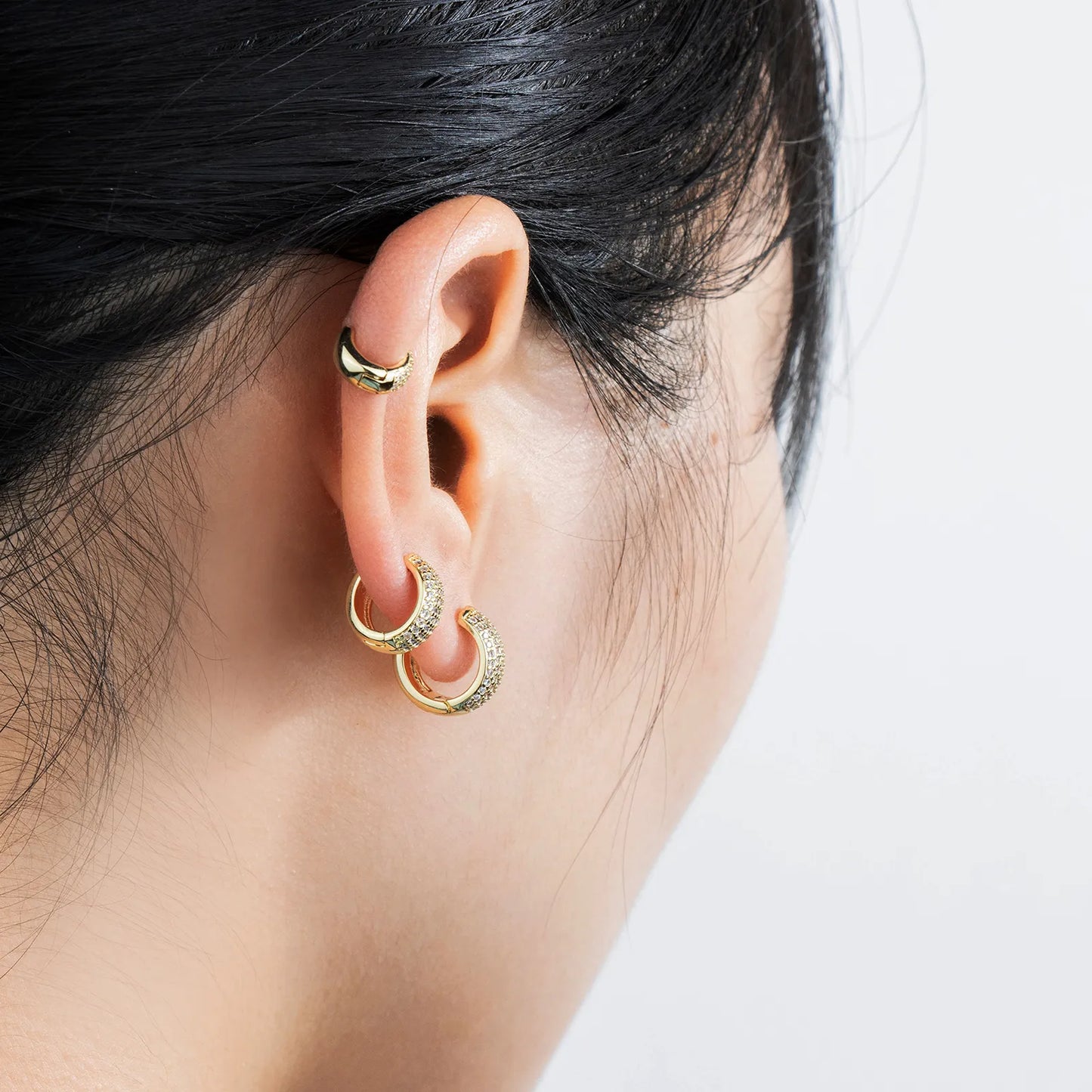 Gold huggie earrings with cubic zirconia, ideal for daily and party styling