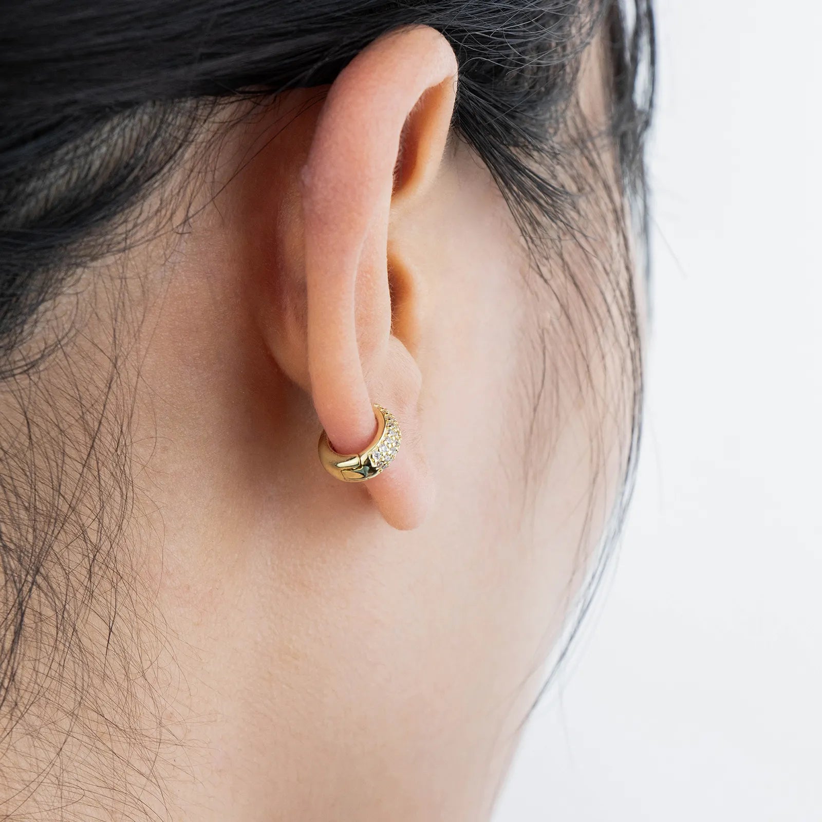 Gold huggie earrings with cubic zirconia, ideal for daily and party styling