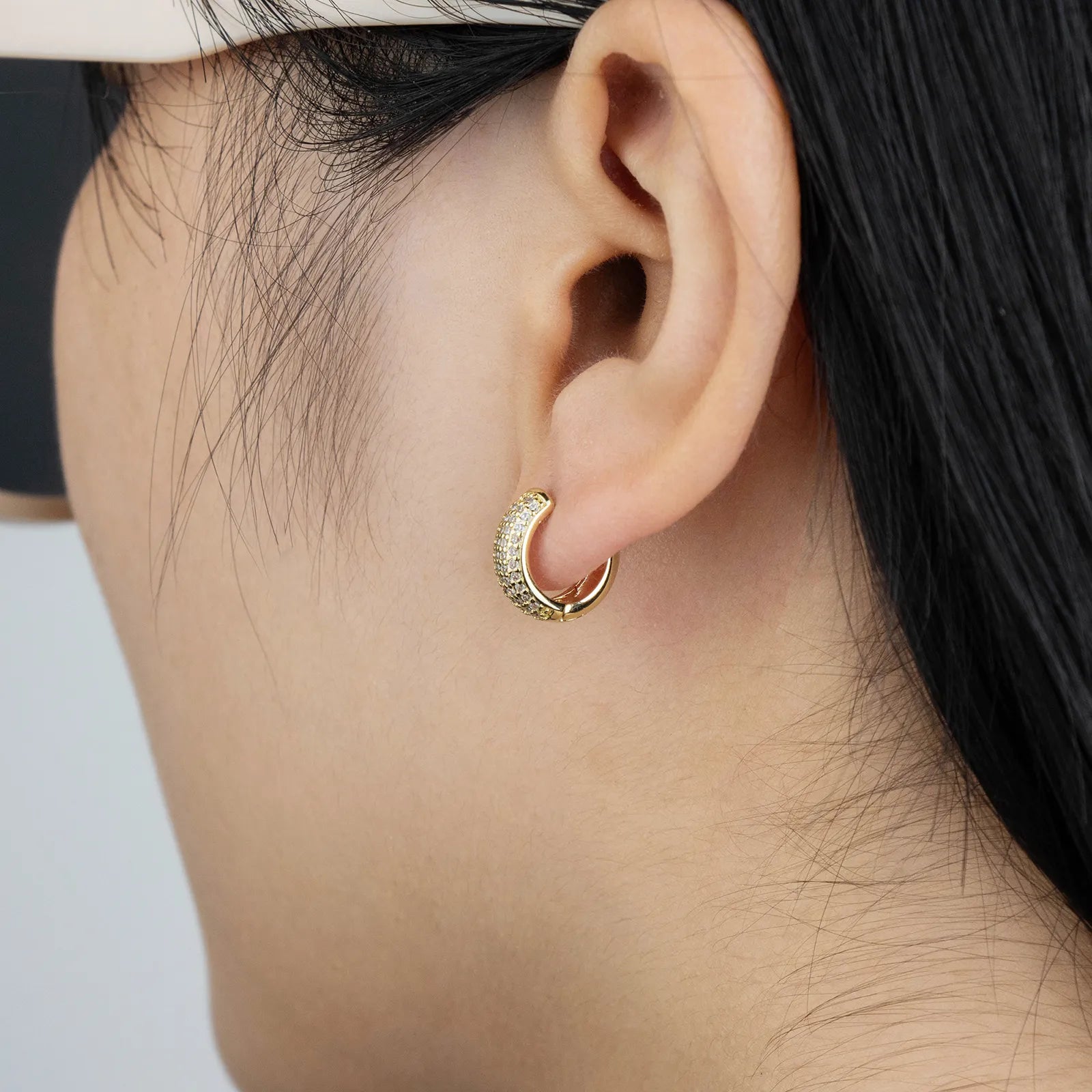 Gold huggie earrings with cubic zirconia, ideal for daily and party styling