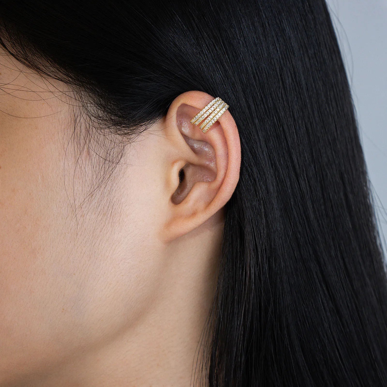 Ajatine gold - tone ear cuffs with four rows of sparkling pave zircons, chic design for fashion wear
