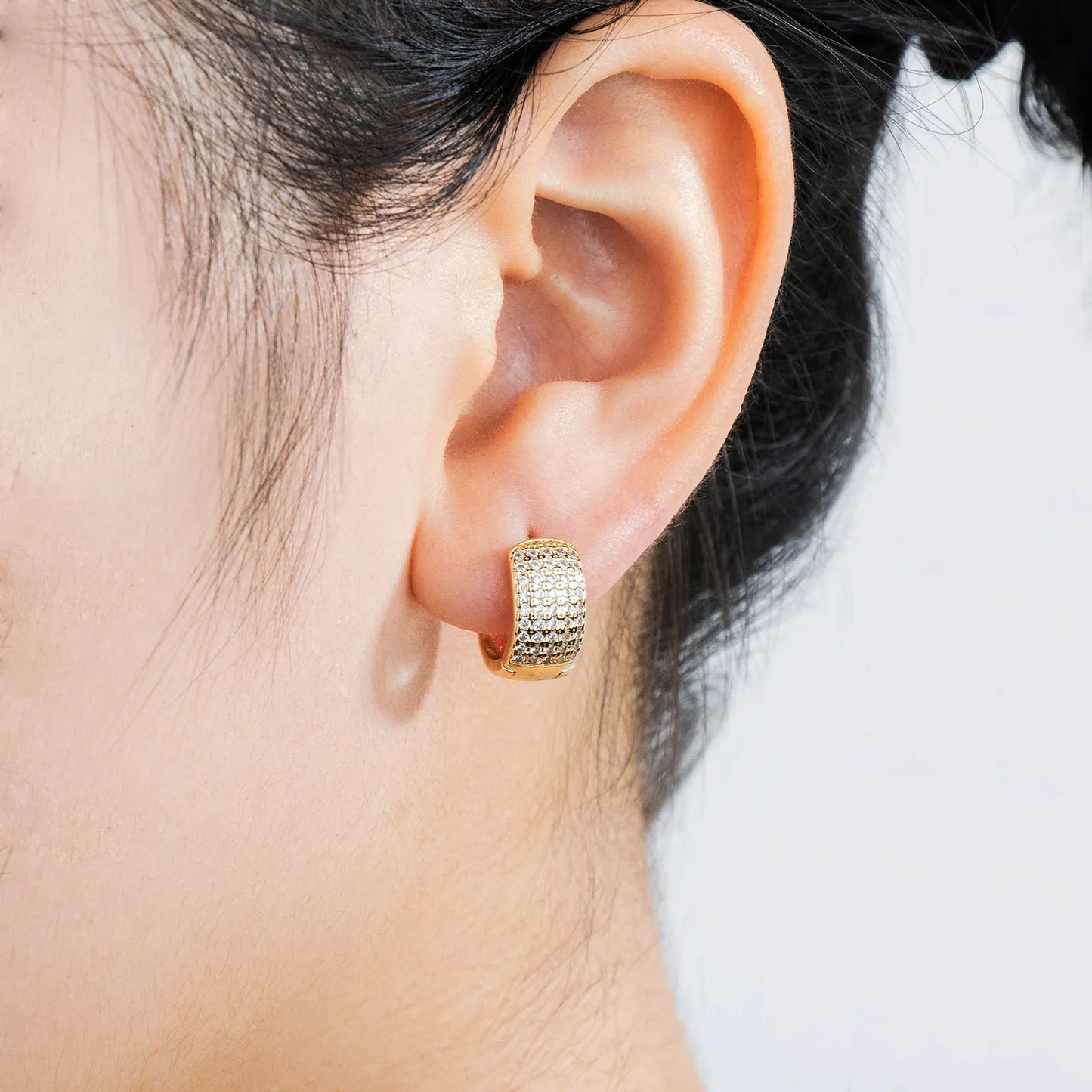 Ajatine brass huggie earrings with wax - set zircon, showcasing elegant design for daily and party wear