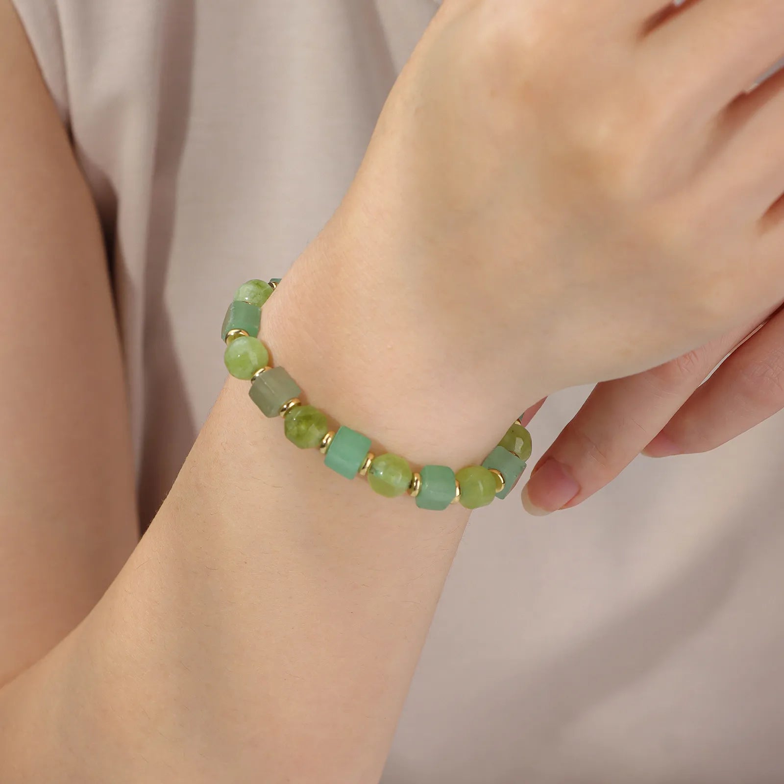 A green beaded bracelet with an elegant design.