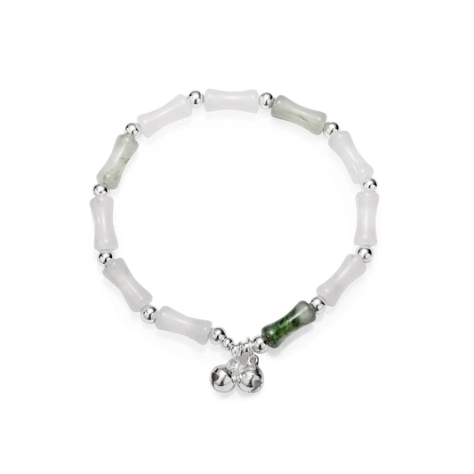 Bead chain bracelet with bamboo - shaped stones and silver bells, showing elegant oriental style.