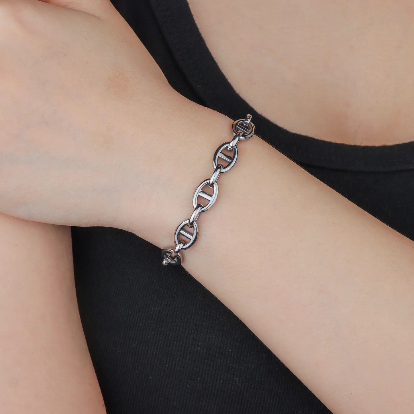 Ajatine silver oval link toggle clasp bracelet close - up view