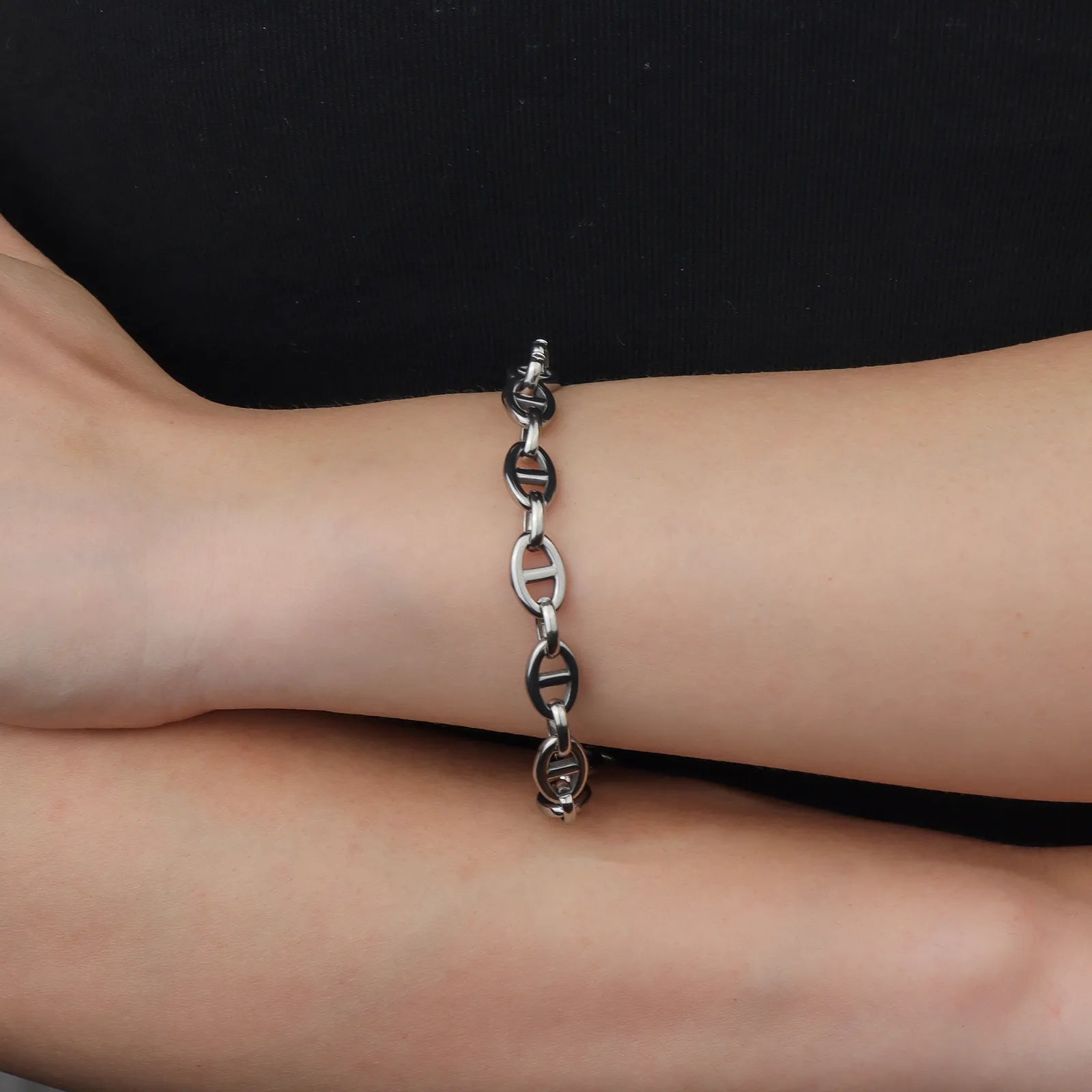 Ajatine silver oval link toggle clasp bracelet close - up view